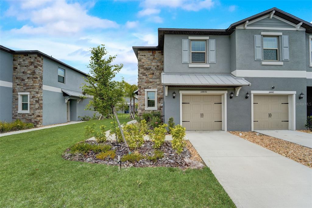 14440 Editors Note Street Ruskin, FL 33573 - Photo 1 of 1 a front view of a house with a garden and yard