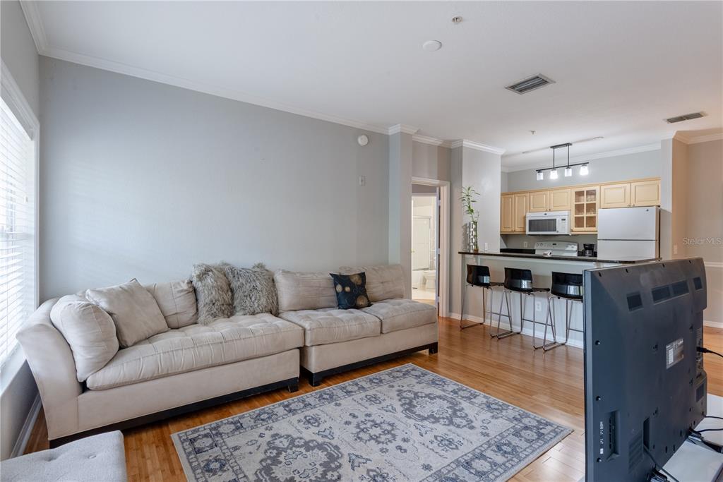 3611 Conroy Road, Unit 834 Orlando, FL 32839 - Photo 12 of 41 a living room with furniture and kitchen view