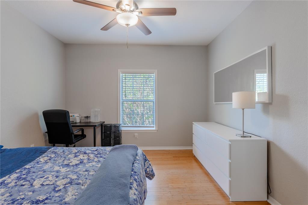 3611 Conroy Road, Unit 834 Orlando, FL 32839 - Photo 18 of 41 a bedroom with a bed and wooden floor