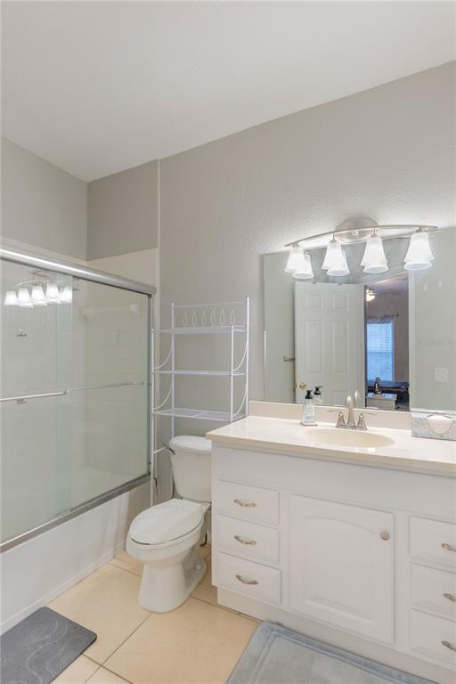 3611 Conroy Road, Unit 834 Orlando, FL 32839 - Photo 24 of 41 a bathroom with a double vanity sink toilet mirror and shower