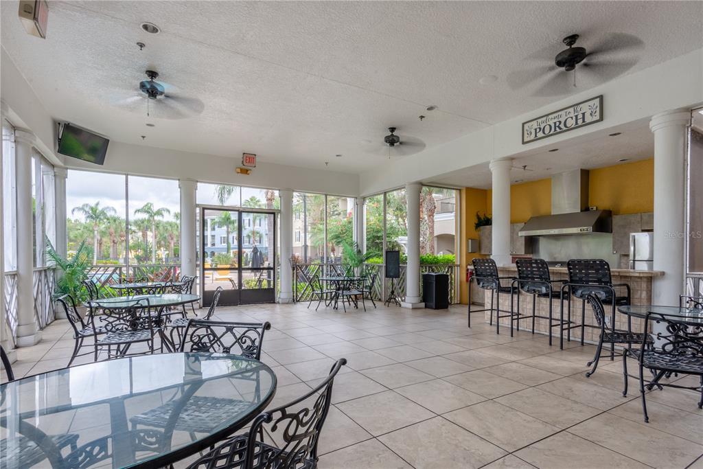 3611 Conroy Road, Unit 834 Orlando, FL 32839 - Photo 38 of 41 a room with lots of tables a large window and chairs