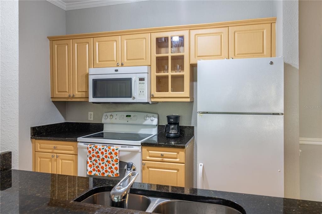3611 Conroy Road, Unit 834 Orlando, FL 32839 - Photo 7 of 41 a kitchen with stainless steel appliances a stove a microwave and a refrigerator
