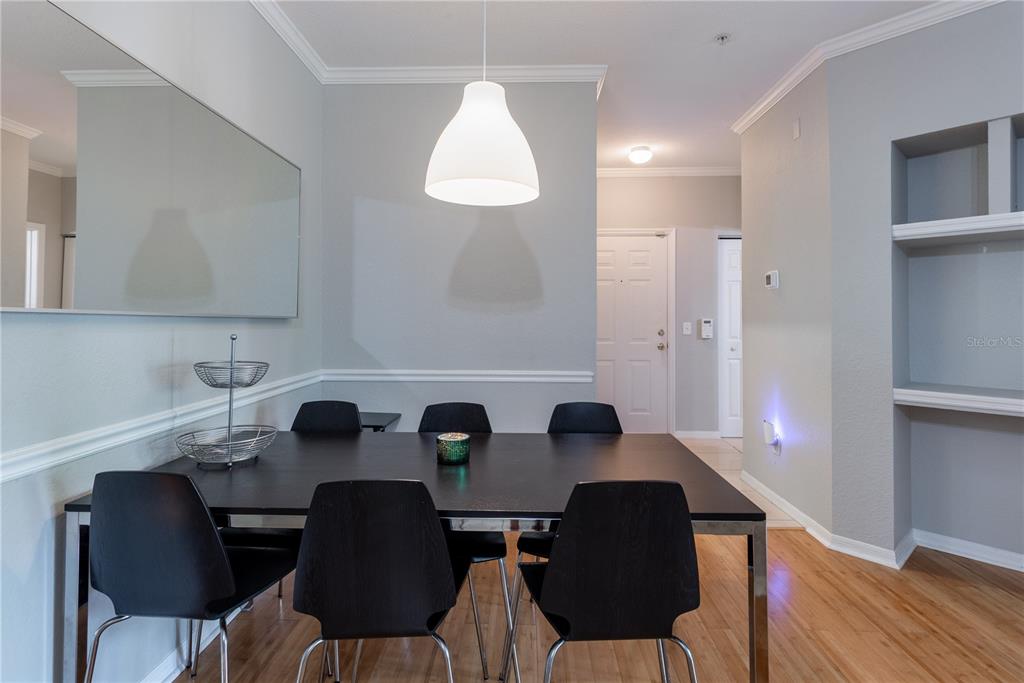 3611 Conroy Road, Unit 834 Orlando, FL 32839 - Photo 10 of 41 a view of a dining room with furniture and wooden floor