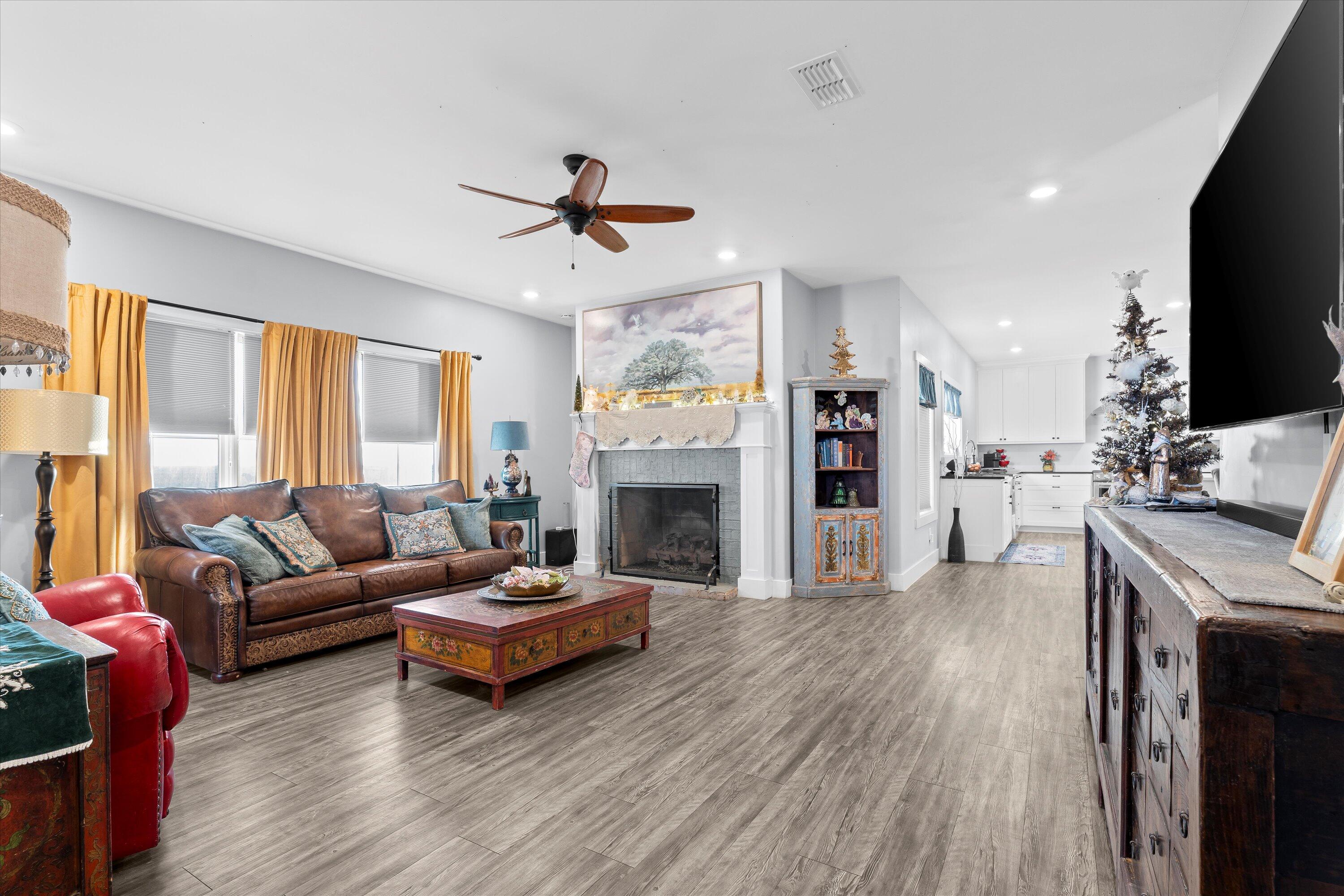3370 Drill Stem Road Levelland, TX 79336 - Photo 14 of 59 a living room with furniture a fireplace and a flat screen tv