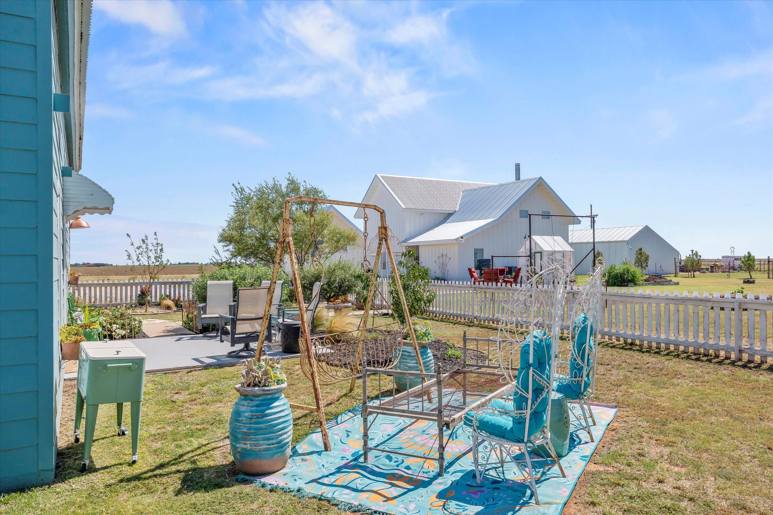 3370 Drill Stem Road Levelland, TX 79336 - Photo 40 of 59 a view of a patio with couches table and chairs and potted plants