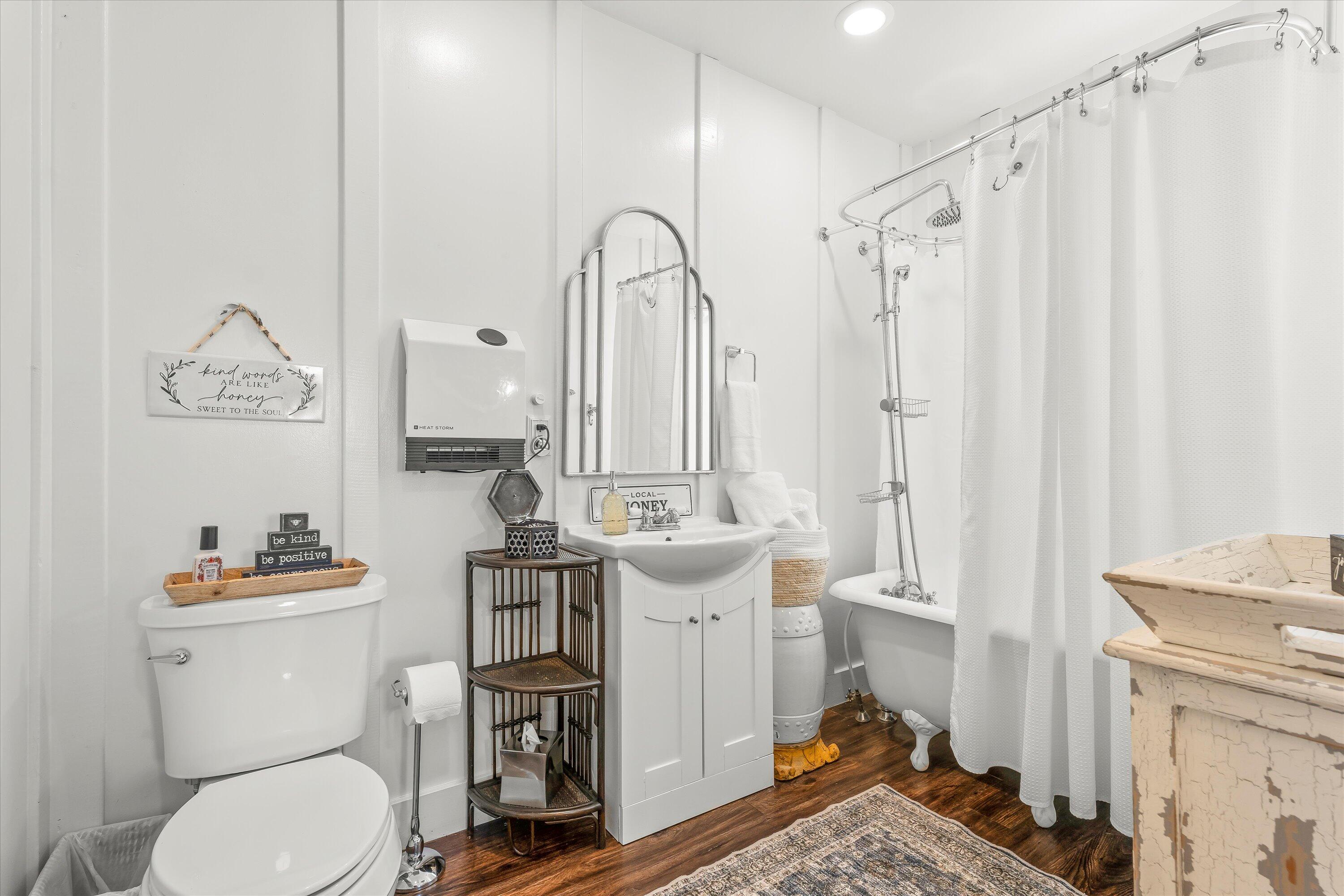 3370 Drill Stem Road Levelland, TX 79336 - Photo 46 of 59 a bathroom with a toilet a sink and a mirror