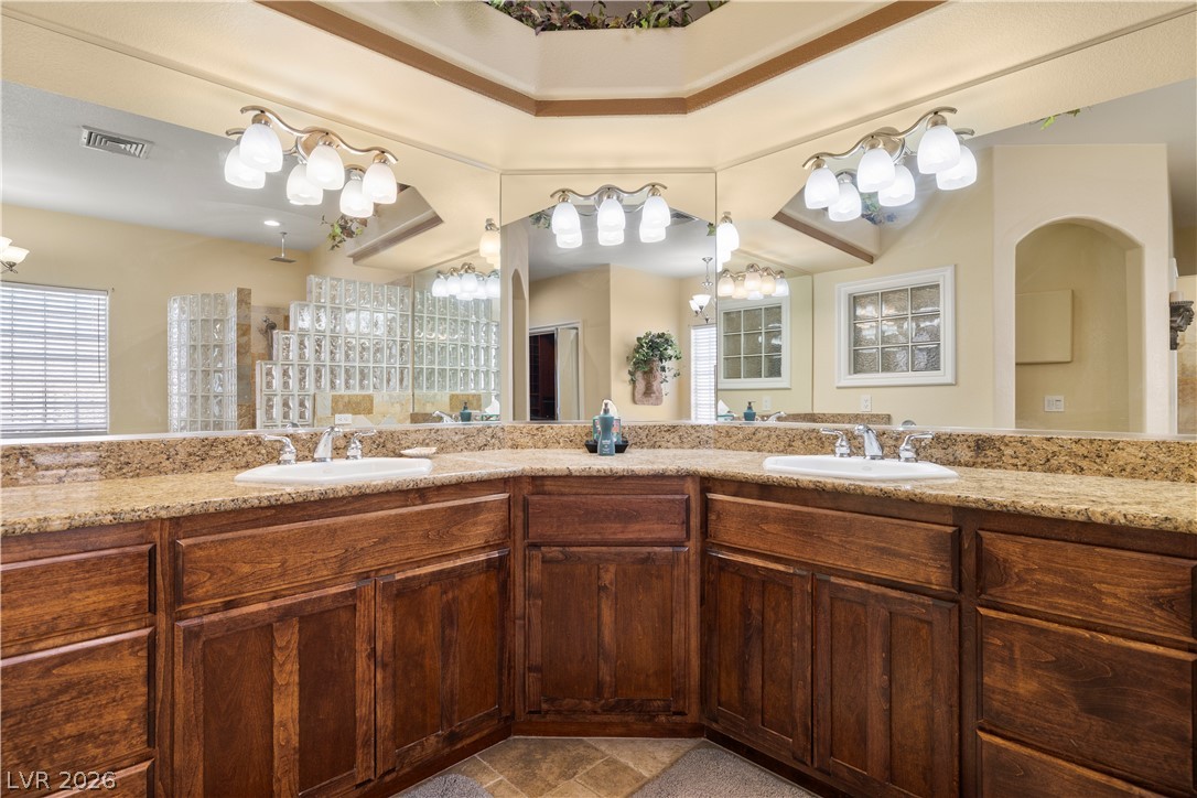 2181 Winery Road Pahrump, NV 89048 - Photo 29 of 52 Double vanities with ample counter space and warm wood cabinetry complete this expansive bathroom.