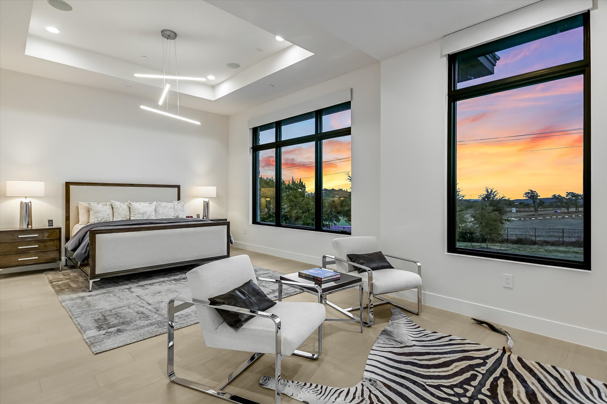 6509 Madrone Tree Lane Austin, TX 78738 - Photo 17 of 40 Bedroom featuring a tray ceiling and light wood-type flooring