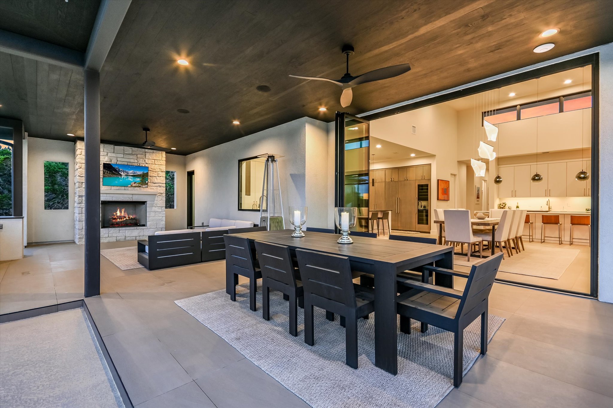 6509 Madrone Tree Lane Austin, TX 78738 - Photo 32 of 40 View of patio / terrace with an outdoor stone fireplace, an outdoor living / dining area, and ceiling fan