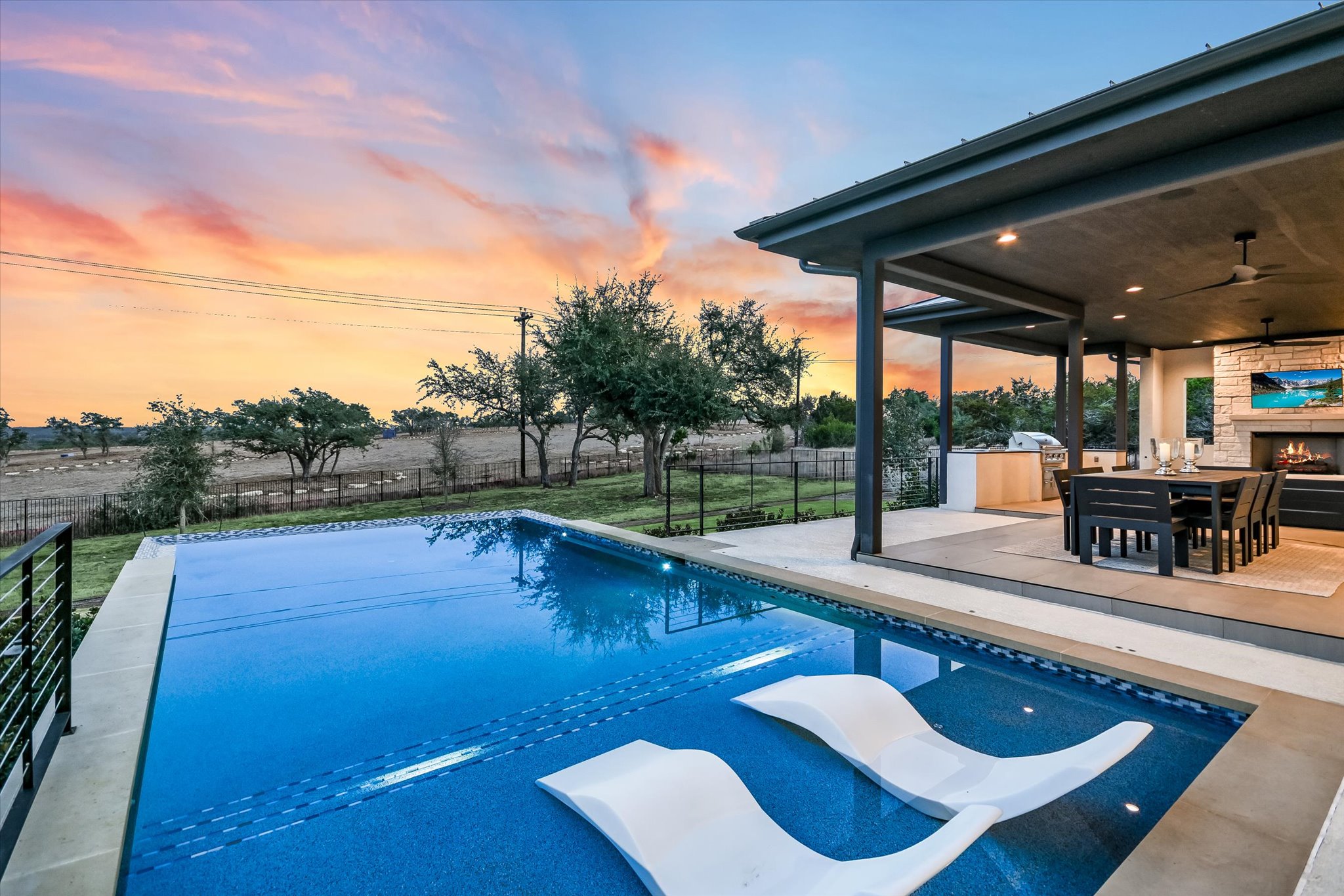 6509 Madrone Tree Lane Austin, TX 78738 - Photo 34 of 40 View of pool featuring patio surround, a fenced backyard, and an outdoor stone fireplace