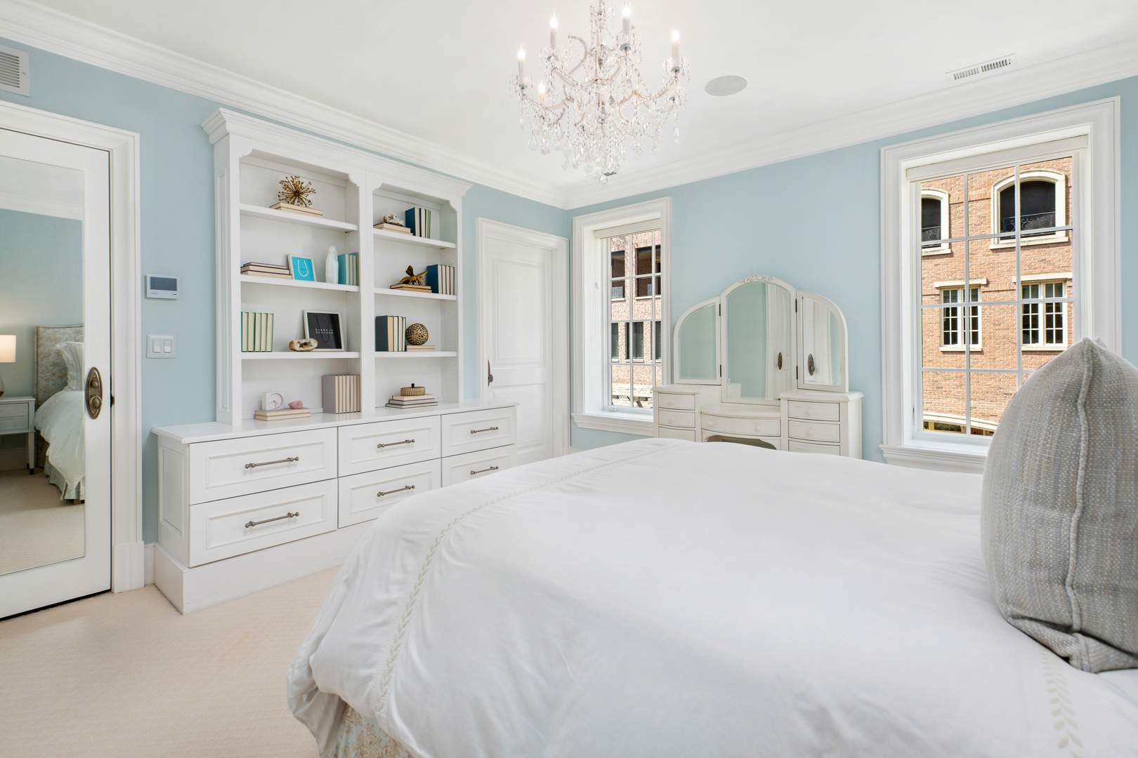 446 West Huron Street Chicago, IL 60654 - Photo 24 of 45 a spacious bedroom with a bed a window and a chandelier