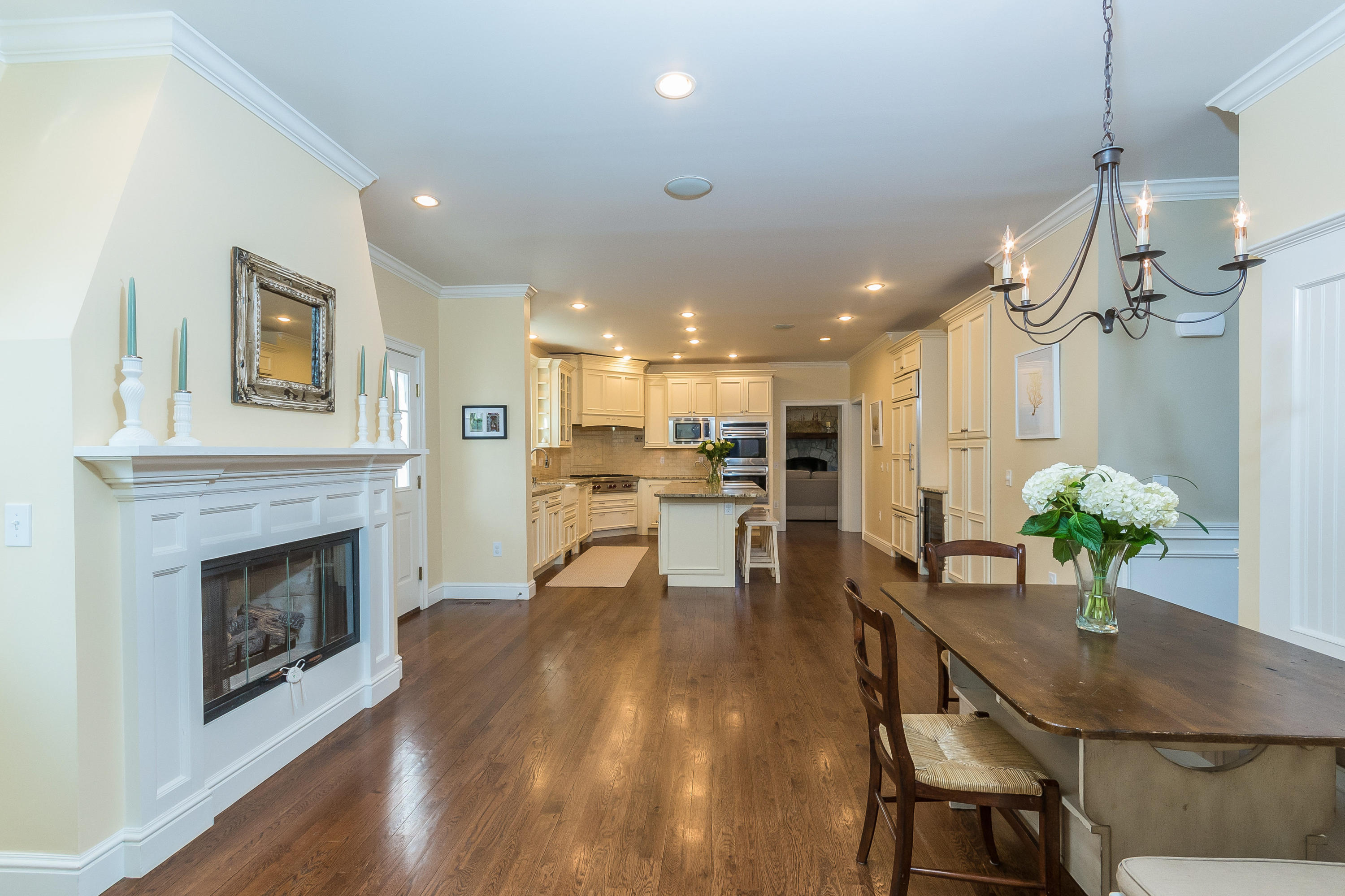 4 Beach Drive Darien, CT 06820 - Photo 14 of 47 a view of a dining room and livingroom with furniture wooden floor a fireplace