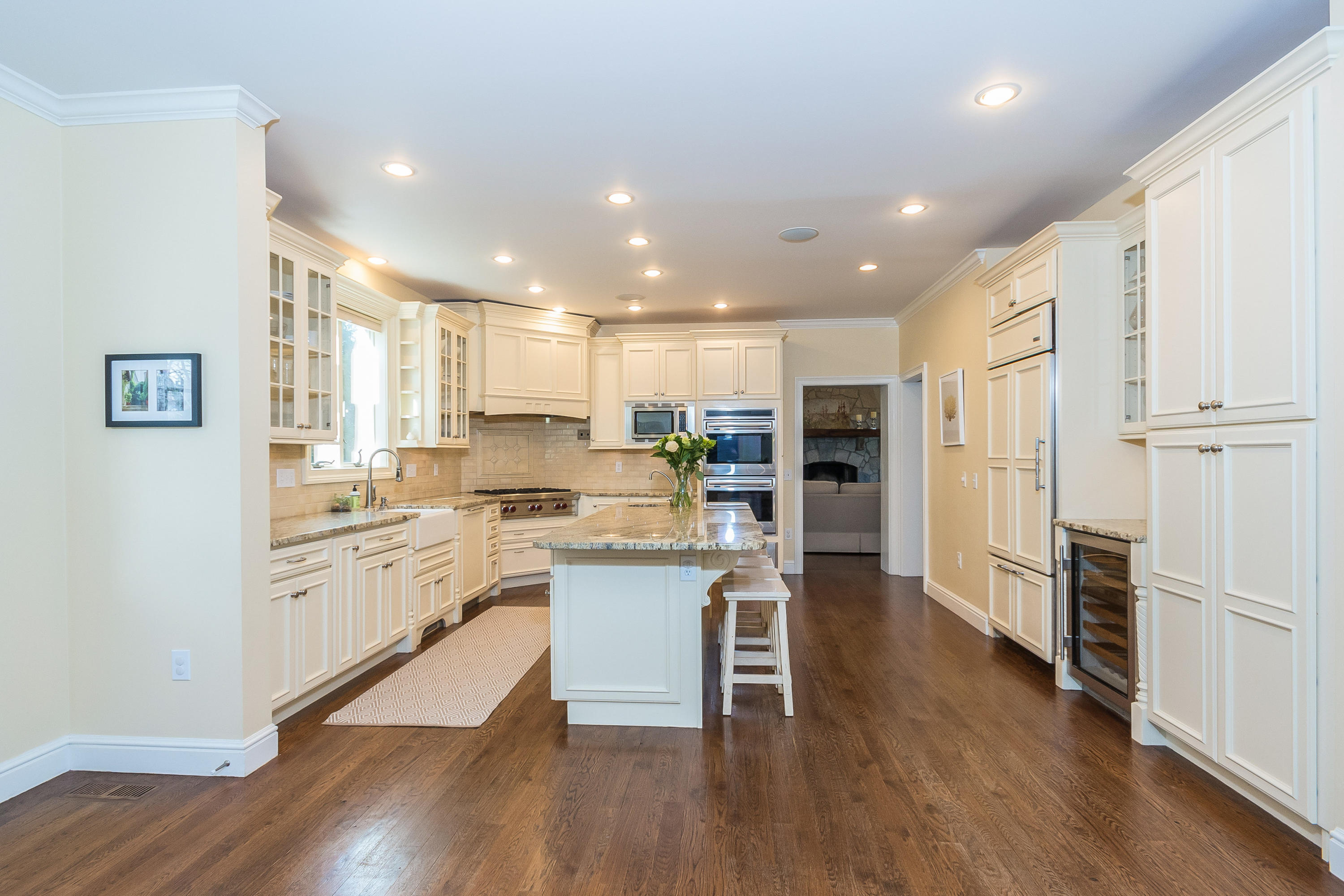 4 Beach Drive Darien, CT 06820 - Photo 18 of 47 a kitchen with white cabinets and stainless steel appliances