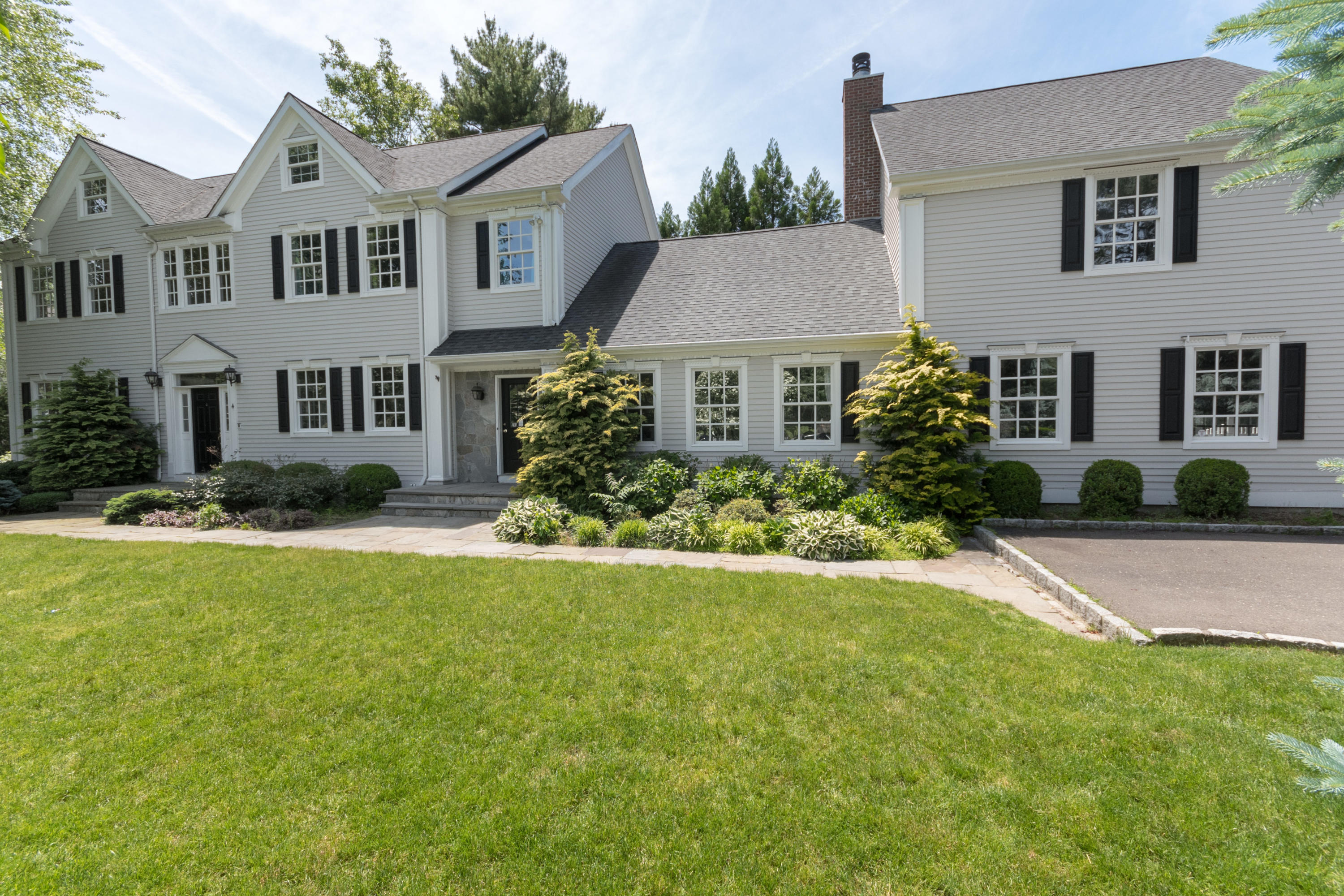 4 Beach Drive Darien, CT 06820 - Photo 2 of 47 a front view of a house with garden