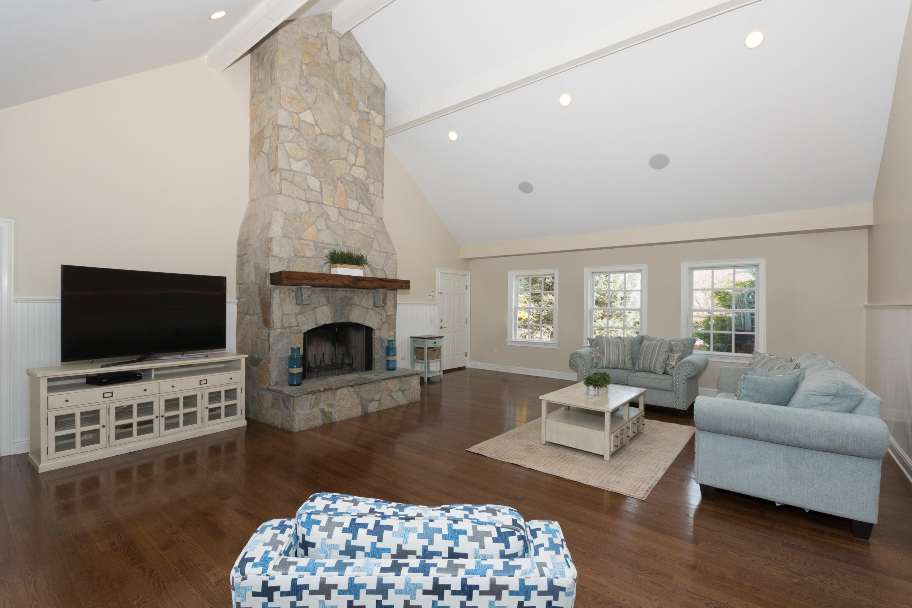 4 Beach Drive Darien, CT 06820 - Photo 21 of 47 a living room with furniture a flat screen tv and a fireplace