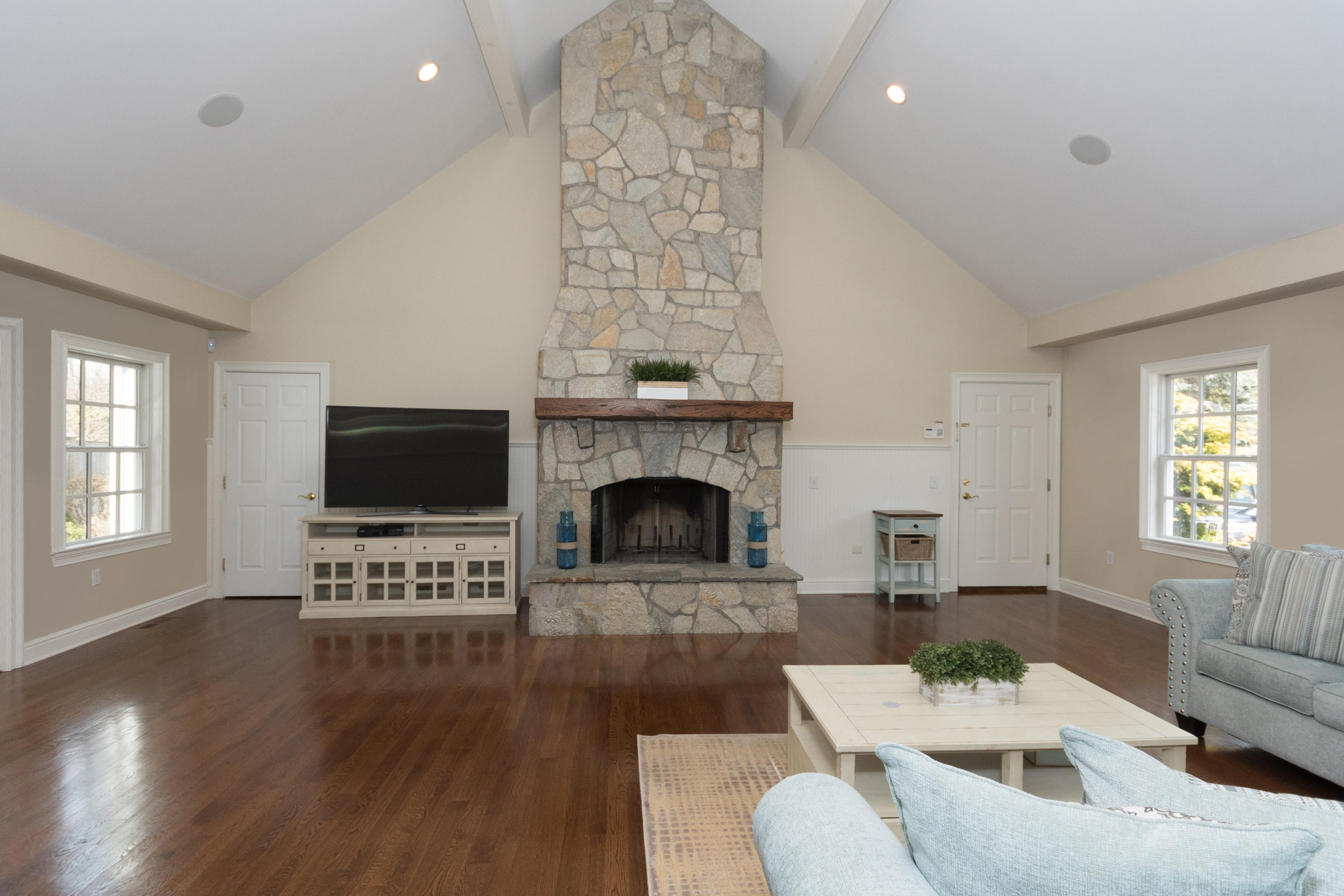 4 Beach Drive Darien, CT 06820 - Photo 22 of 47 a living room with furniture a flat screen tv and a fireplace