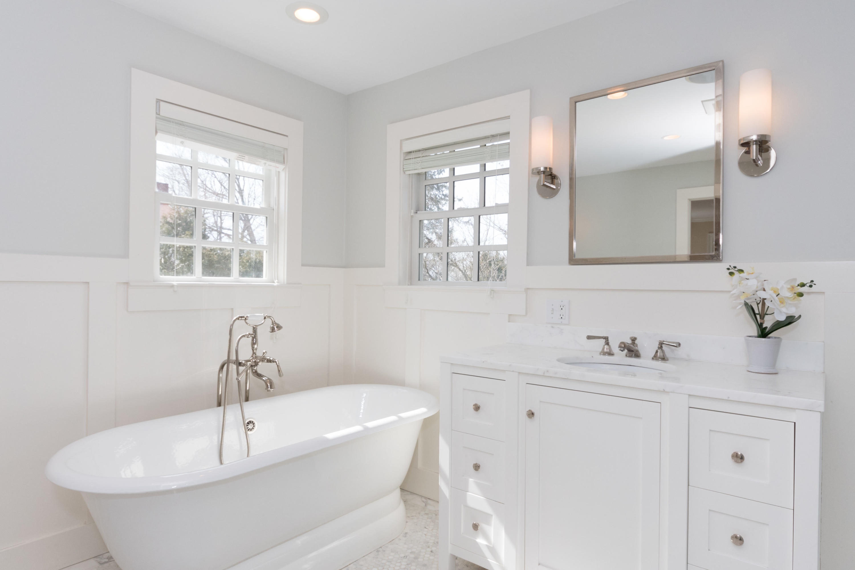 4 Beach Drive Darien, CT 06820 - Photo 28 of 47 a white bath tub sitting in a bathroom next to a window
