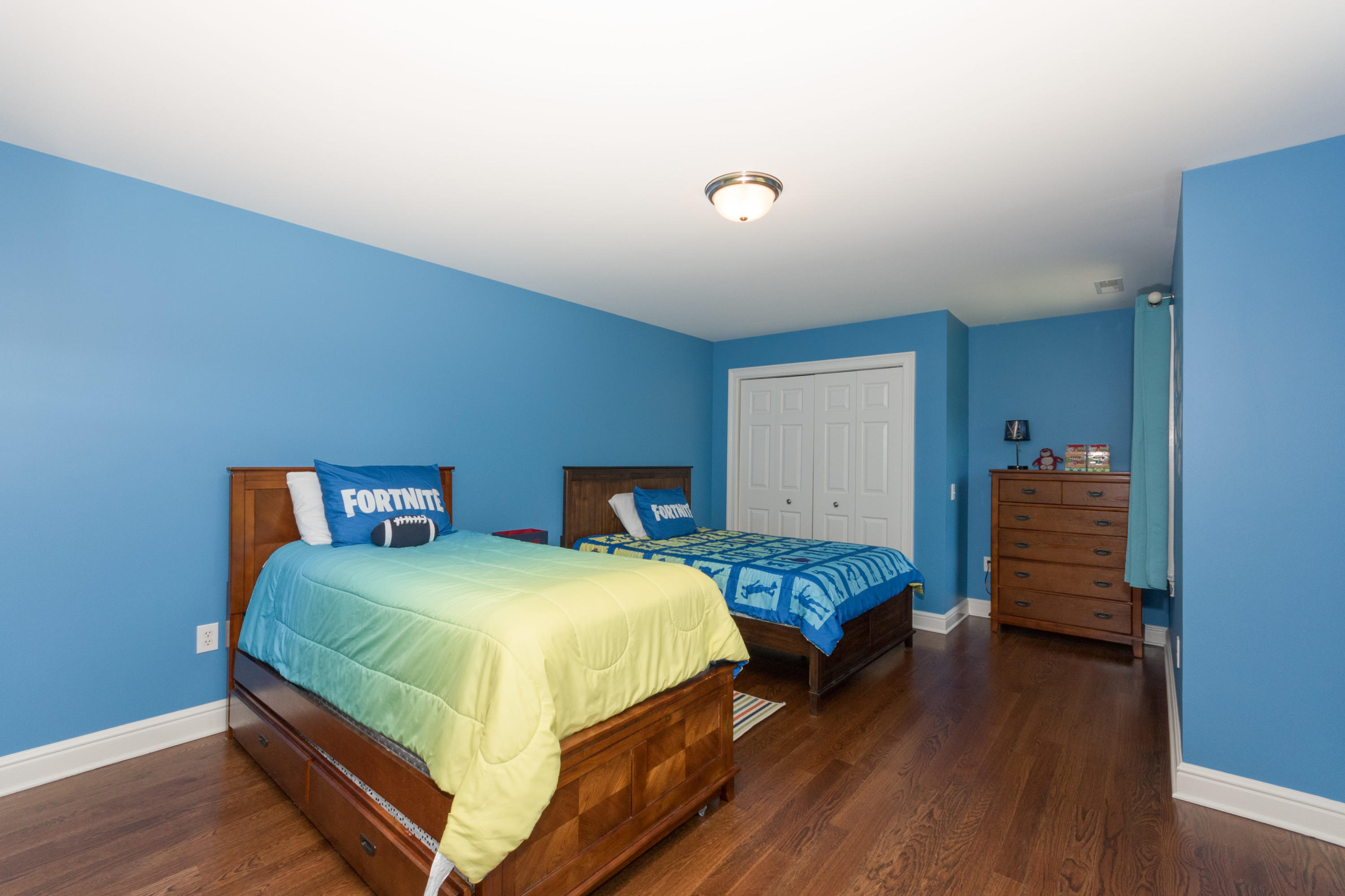 4 Beach Drive Darien, CT 06820 - Photo 29 of 47 a bedroom with two beds and wooden floor