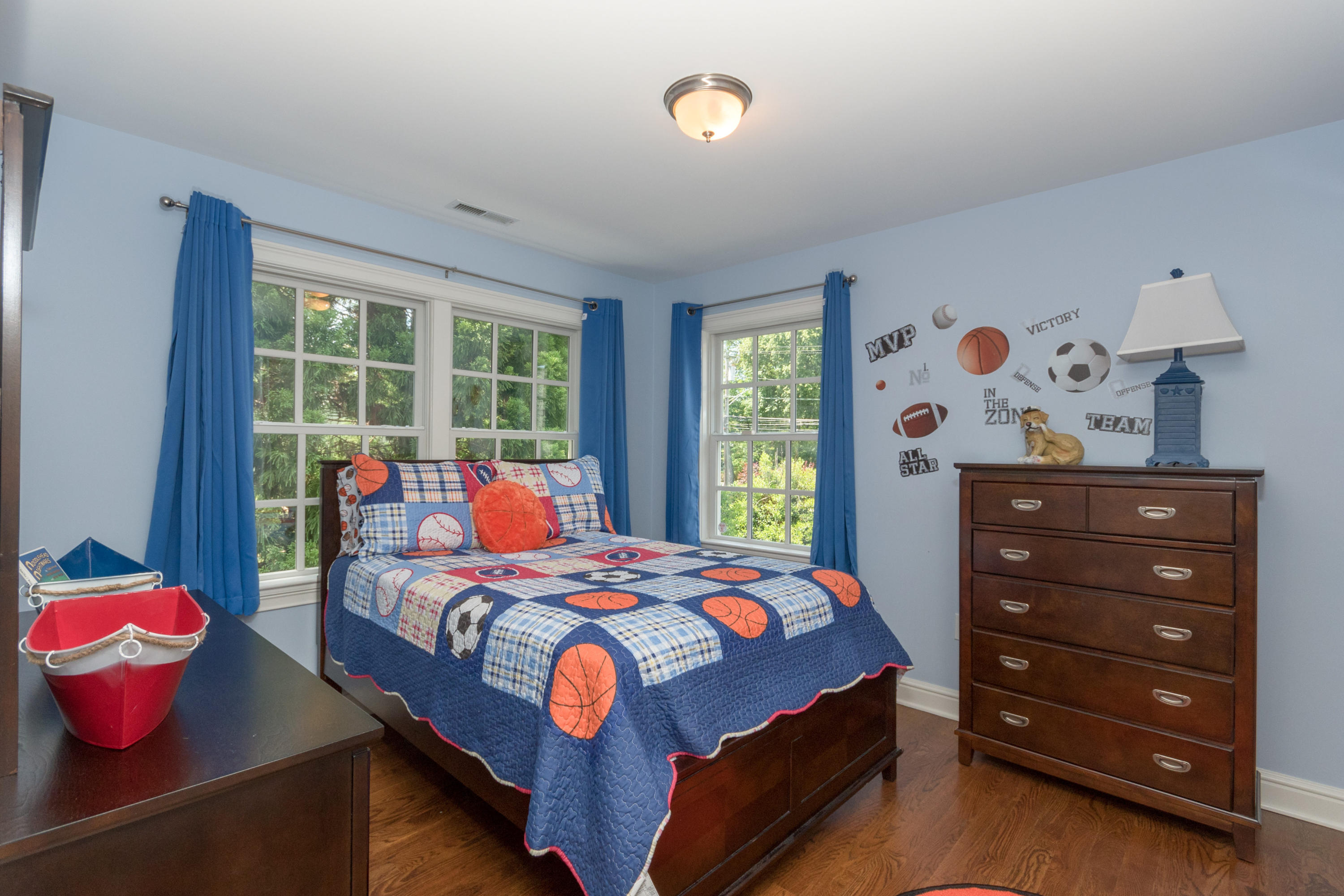 4 Beach Drive Darien, CT 06820 - Photo 31 of 47 a bedroom with a bed and wooden floor