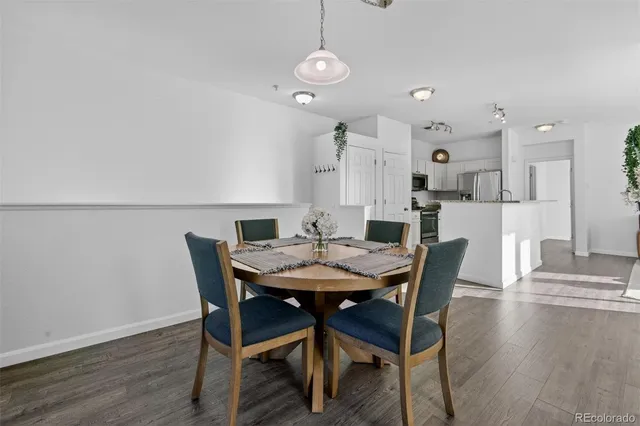 a view of a dining room with furniture and wooden floor