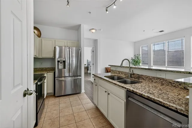 a kitchen with a sink stove and refrigerator