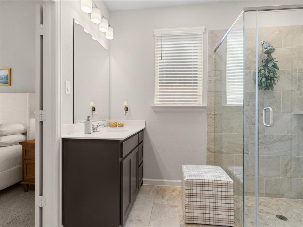 166 Palo Duro Bend Rhome, TX 76078 - Photo 24 of 40 Primary bathroom featuring dual vanities, walk-in shower, and ample storage.