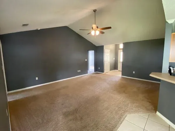 a view of a livingroom with a chandelier fan