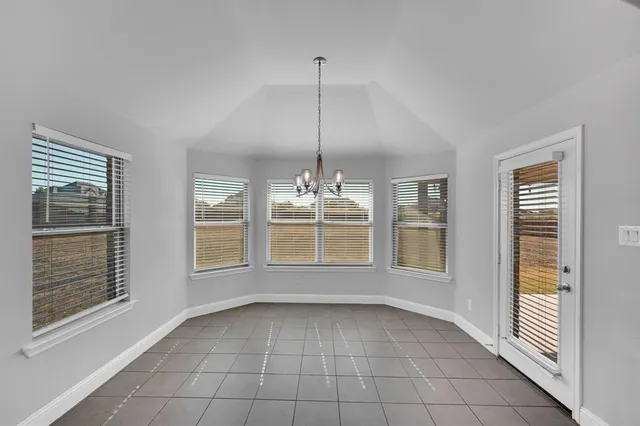 a kitchen with stainless steel appliances granite countertop a sink a oven and a large window with wooden floor