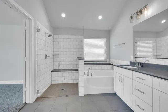 a bathroom with a sink double vanity and a shower
