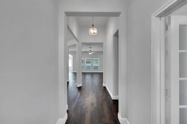 a bathroom with a sink a toilet and a large mirror