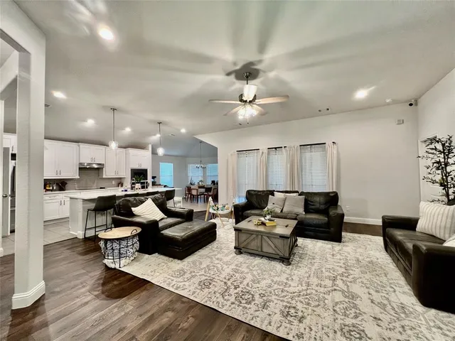 a living room with furniture or kitchen view and a wooden floor