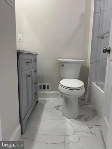 a bathroom with a toilet and a sink