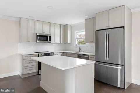 a kitchen with appliances a sink and a window