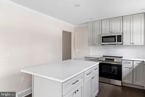 a kitchen with a stove and a microwave