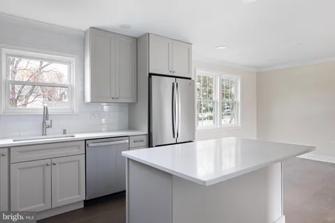 a kitchen with a sink a window and stainless steel appliances