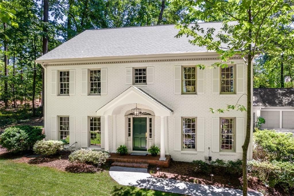943 Barton Woods Road Northeast Atlanta, GA 30307 - Photo 1 of 1 a view of a white house with a yard and plants
