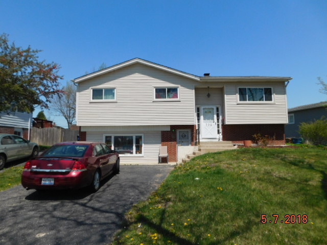 726 Terry Road Glendale Heights, IL 60139 - Photo 1 of 27 a house view with a garden space