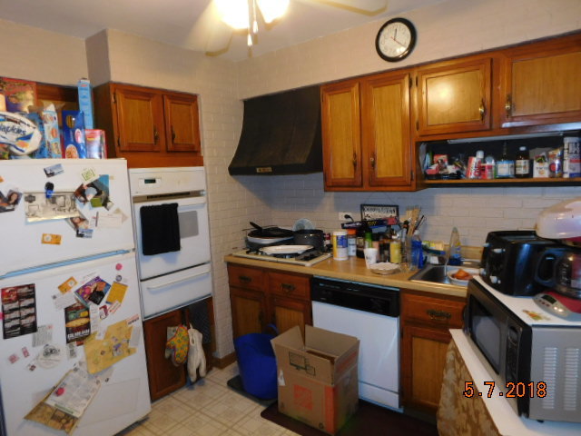 726 Terry Road Glendale Heights, IL 60139 - Photo 13 of 27 a kitchen with a refrigerator and a stove top oven