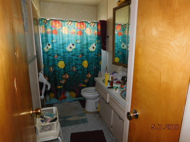 726 Terry Road Glendale Heights, IL 60139 - Photo 16 of 27 a bathroom with a toilet and shower curtain