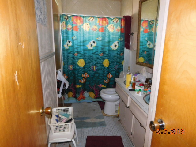 726 Terry Road Glendale Heights, IL 60139 - Photo 17 of 27 a bathroom with a toilet and a shower curtain