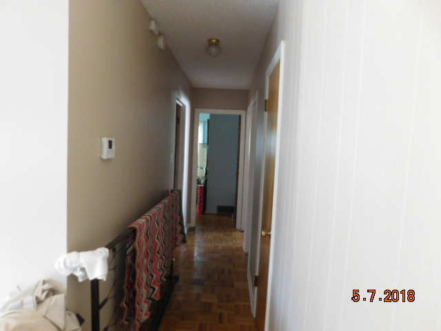 726 Terry Road Glendale Heights, IL 60139 - Photo 22 of 27 a view of a hallway with wooden shelves