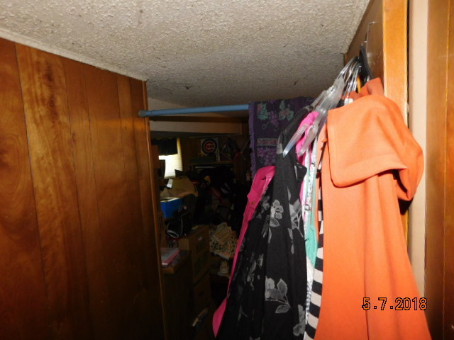 726 Terry Road Glendale Heights, IL 60139 - Photo 24 of 27 a view of walk in closet with clothes and shoes