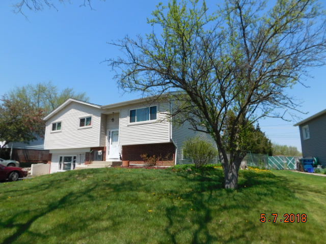 726 Terry Road Glendale Heights, IL 60139 - Photo 3 of 27 a front view of a house with a garden and yard