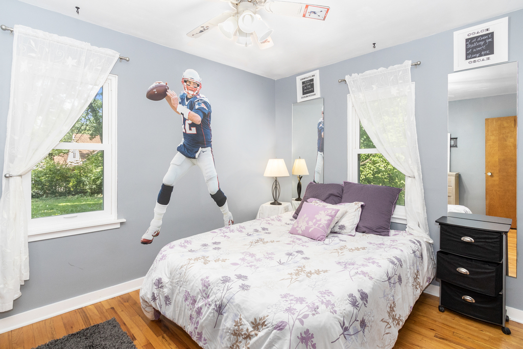 1604 Pine Road Homewood, IL 60430 - Photo 11 of 17 a bedroom with a bed and a chandelier