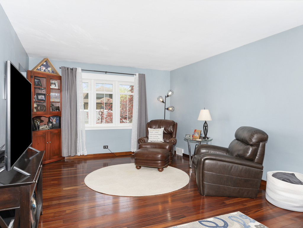 1604 Pine Road Homewood, IL 60430 - Photo 12 of 17 a living room with furniture a flat screen tv and a window