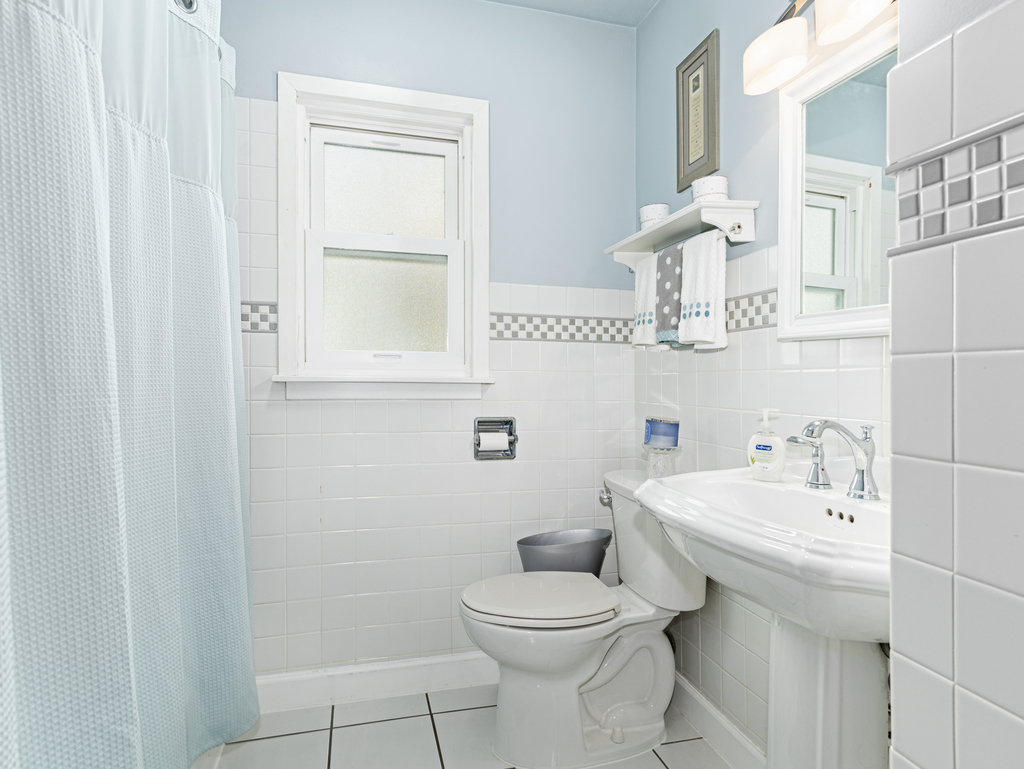 1604 Pine Road Homewood, IL 60430 - Photo 9 of 17 a bathroom with a sink a toilet and mirror