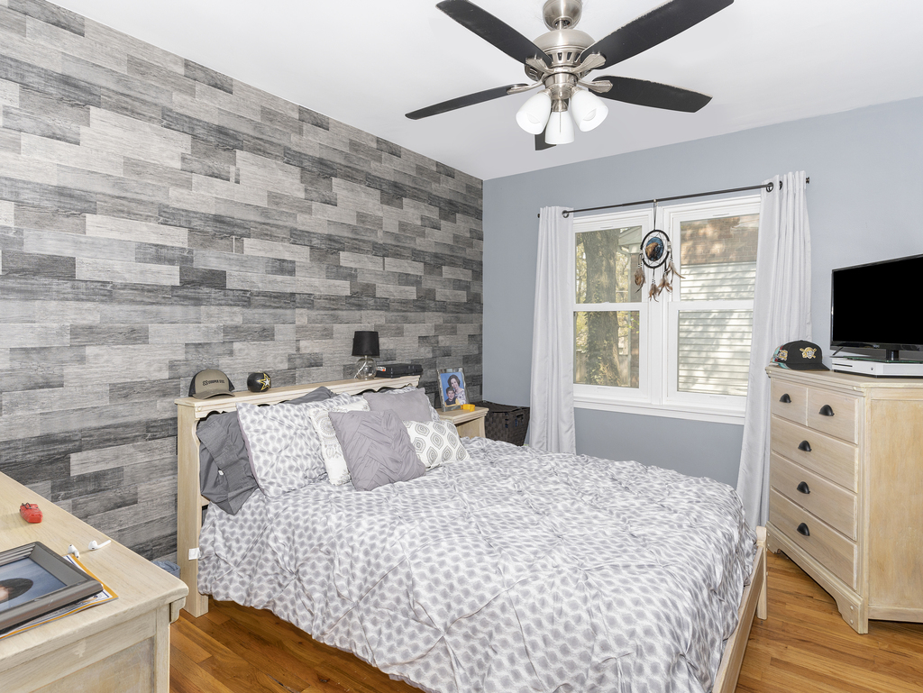 1604 Pine Road Homewood, IL 60430 - Photo 10 of 17 a bedroom with a bed and a flat tv screen on dresser