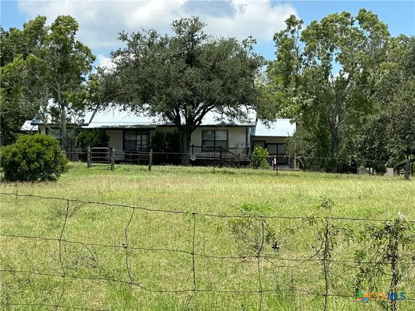 a view of a house with garden and sitting area
