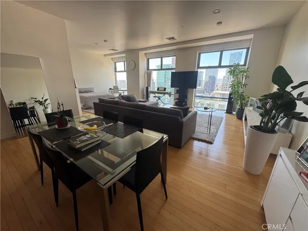 a view of a dining room with furniture and wooden floor