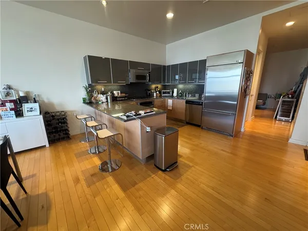 a kitchen with a sink appliances and cabinets